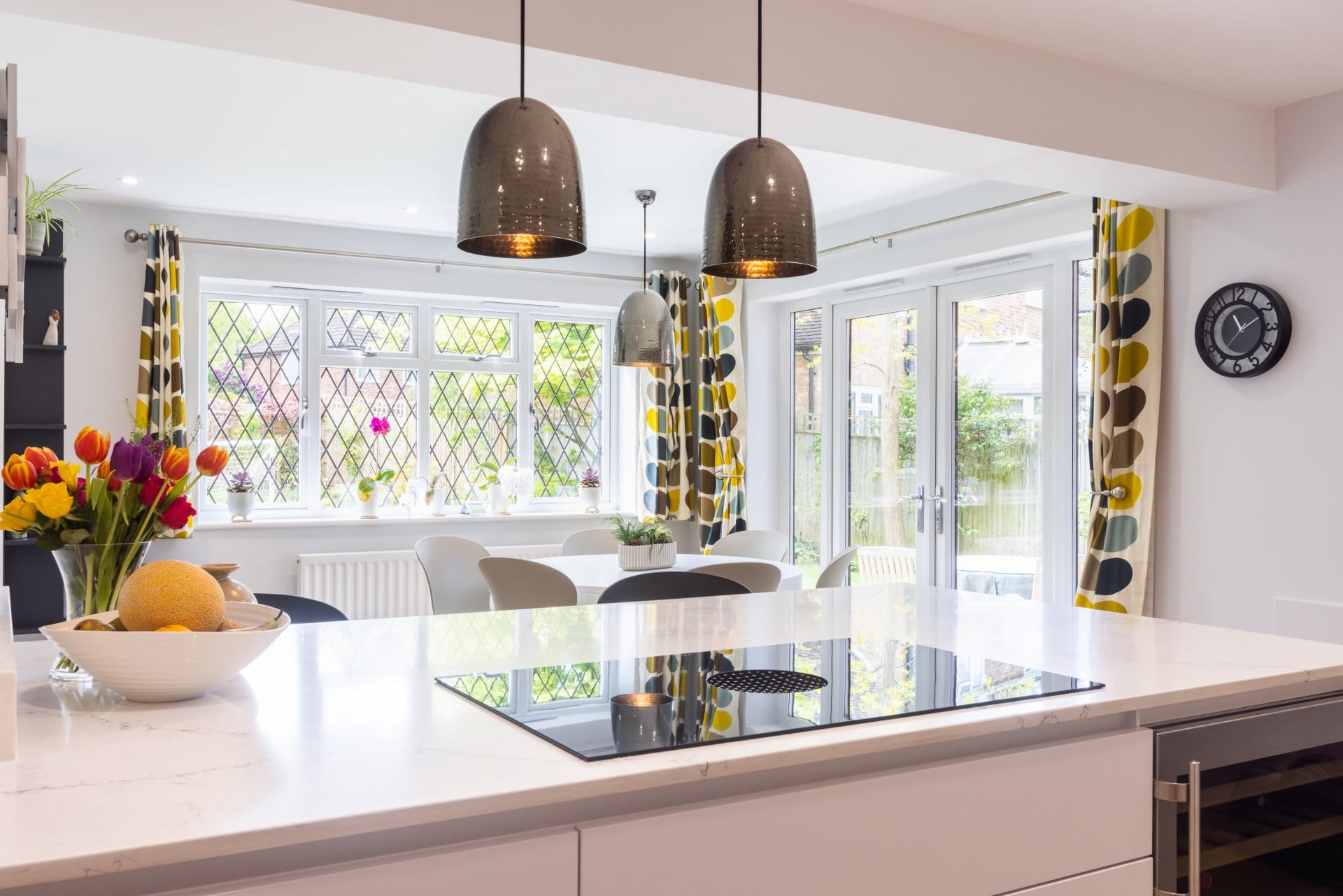 0E8A0035 Artizan Interiors contemporary shaker kitchen featuring a contrasting burgundy island, white cabinetry, quartz worktops and open shelving with modern styling.