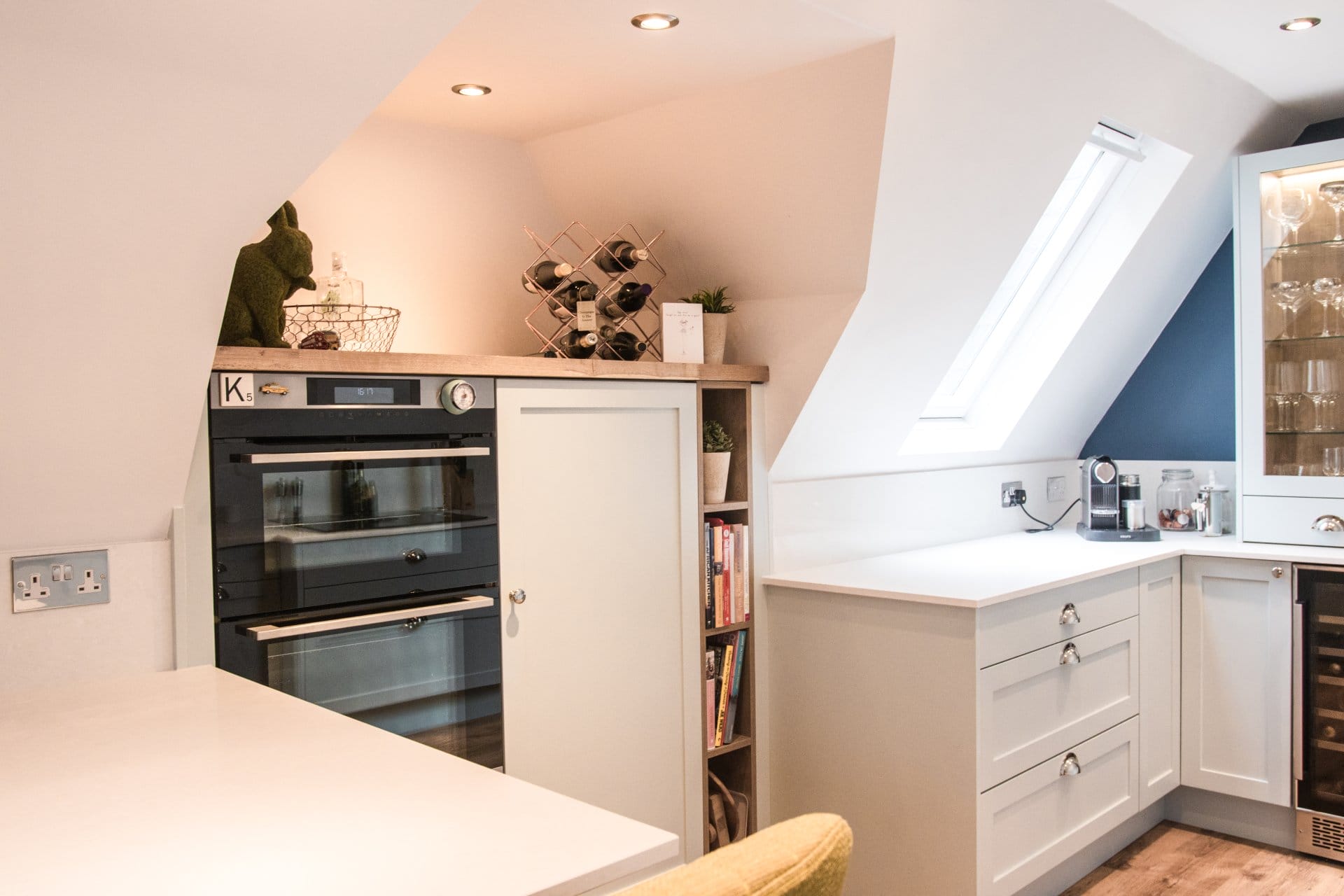 Artizan Manor House Kitchen-4 Artizan Interiors bespoke shaker kitchen cabinetry featuring white drawers with brass handles, floating shelves, oak flooring and contemporary styling details.
